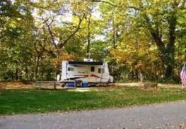 Camper in wooded area.