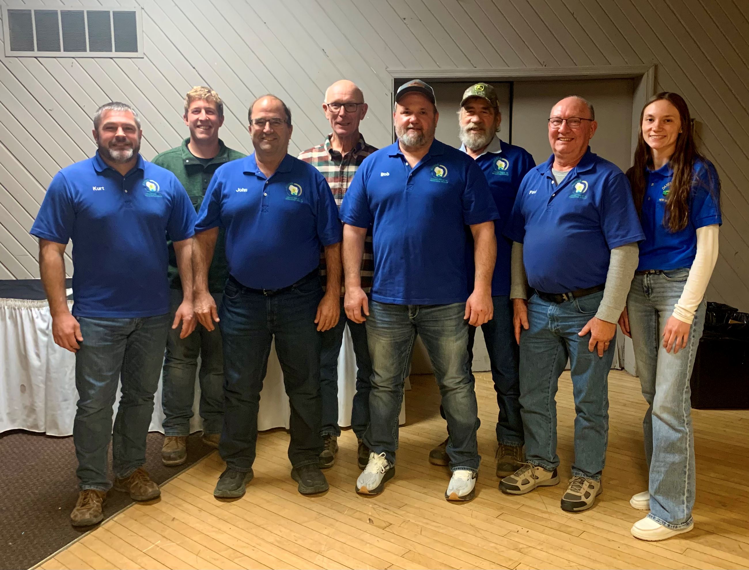 Board of Directors standing as a group, 7 men and 1 woman.